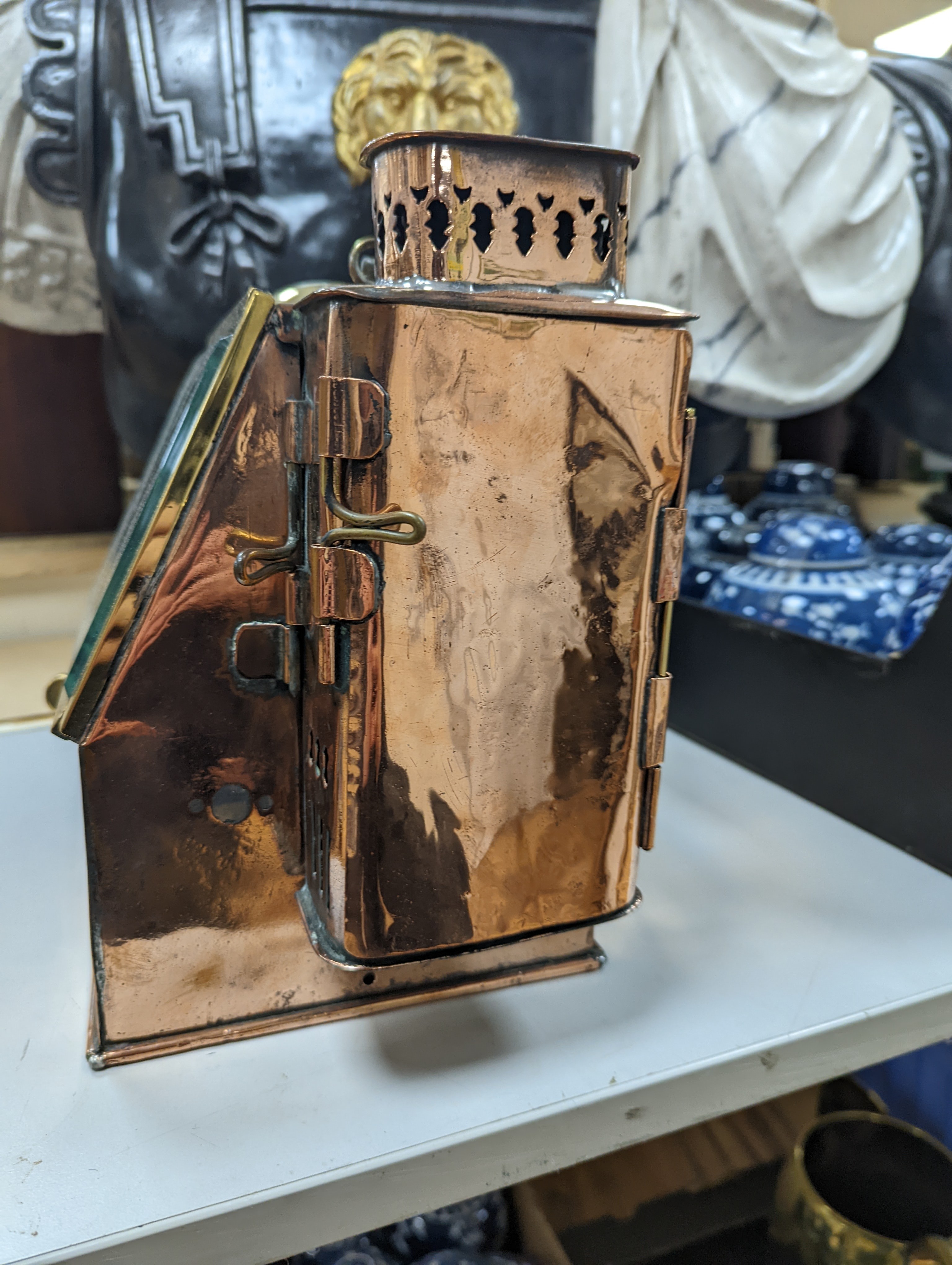 A copper ship's binnacle compass, a brass oil lamp, a brass jug and a copper kettle